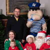 Family of five with Santa and Louie the Laker at the event.